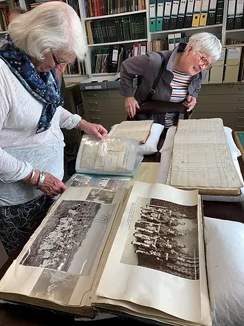 Members of SRA group looking at archival materials